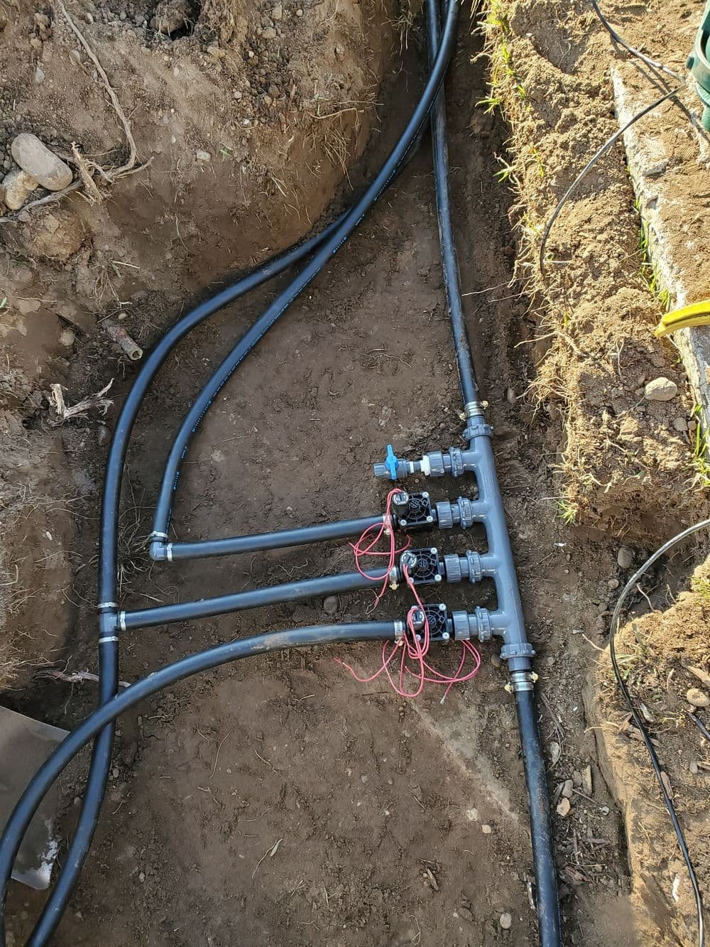 Underground irrigation system with valves and connected tubing.